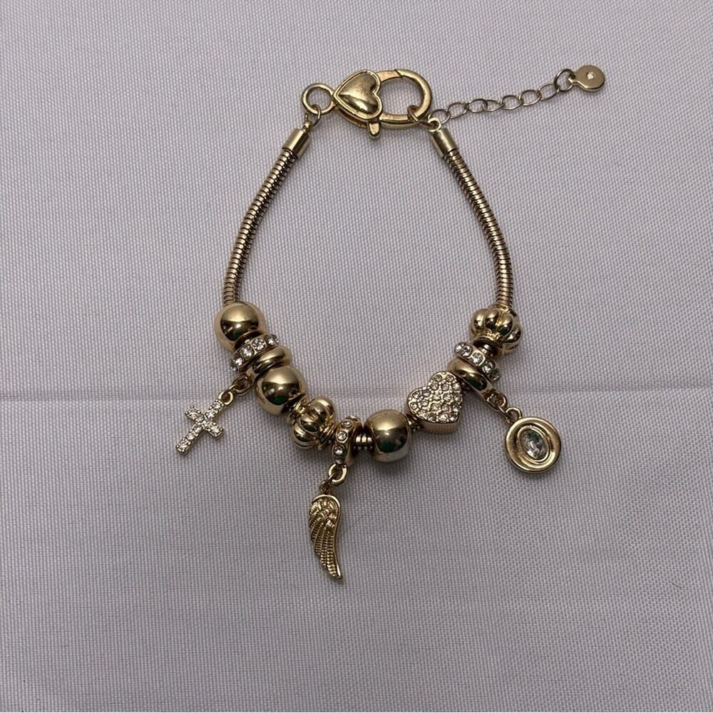 Gold Tone Charm Bracelet with Heart and Wing and Cross Accents